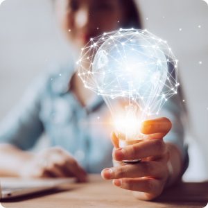 A team member holding a glowing lightbulb